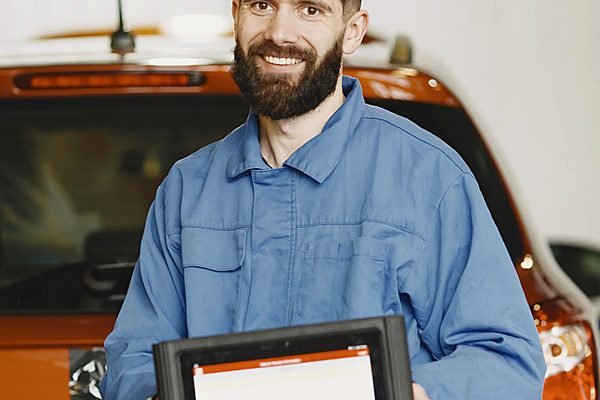 Technician using a diagnostic tablet in a workshop