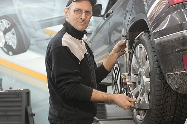 Wheel and tyre alongside a wheel alignment readout