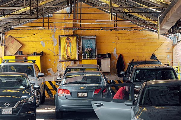 Multi-bay workshop floor with vehicle on a lift
